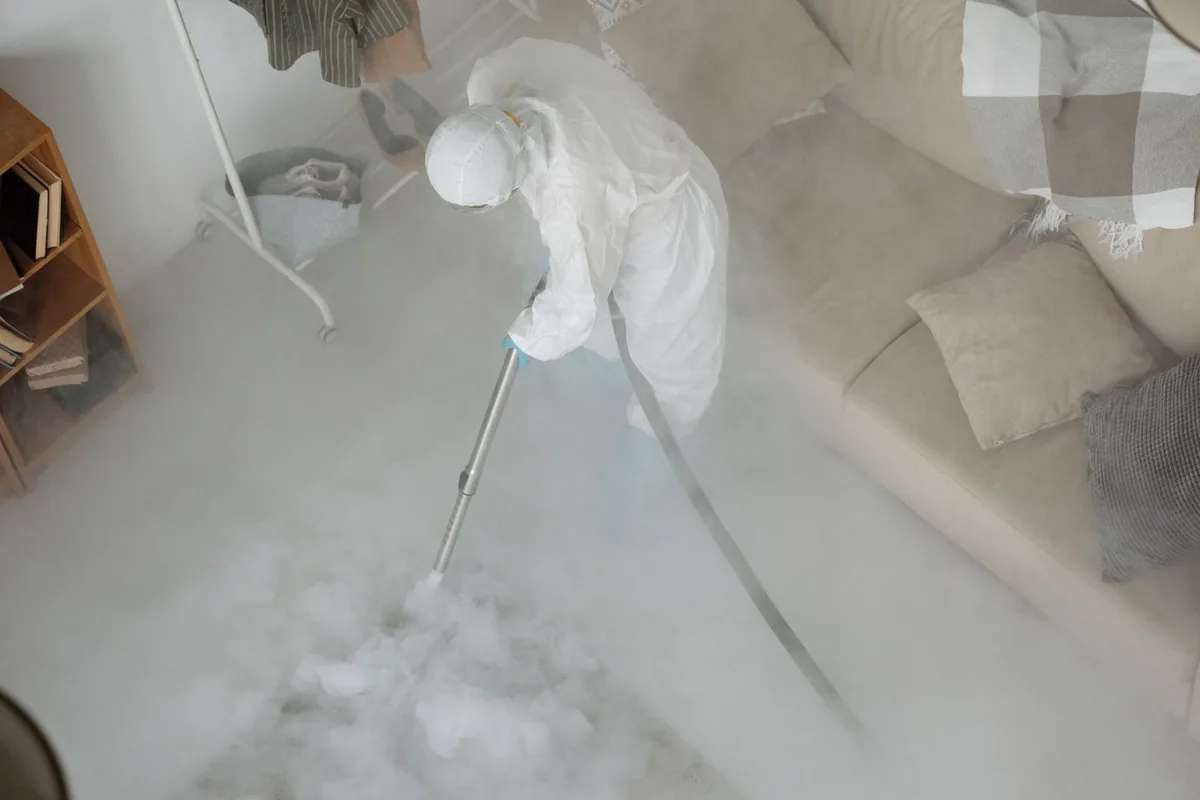 Biohazard cleanup technician in protective equipment, St. Helens, OR